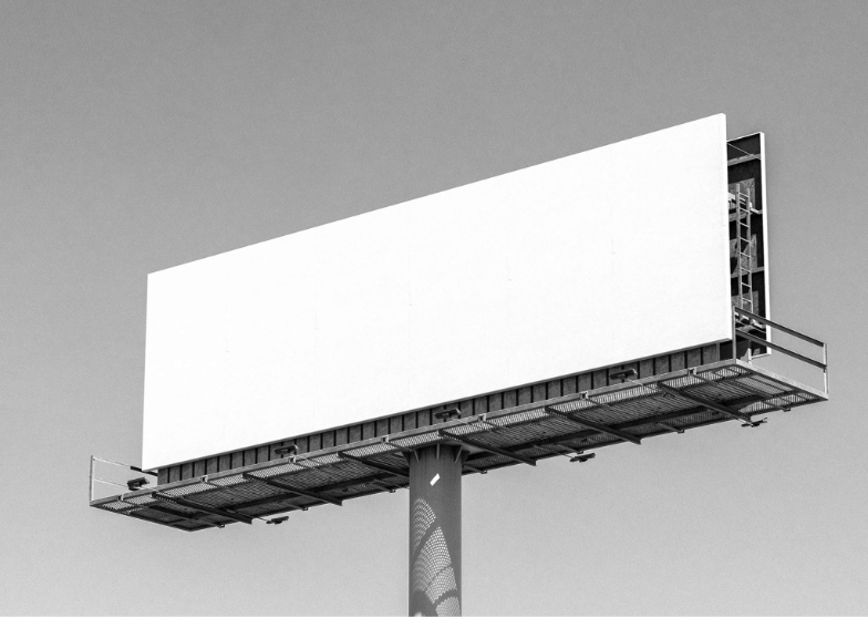 Image displays a large advertising board displaying a blank white image, the background is a grey clear sky