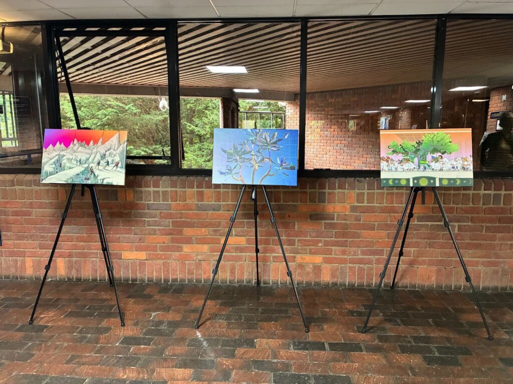 Three easels each with images from the library printed on canvas on display in Cambridge.  