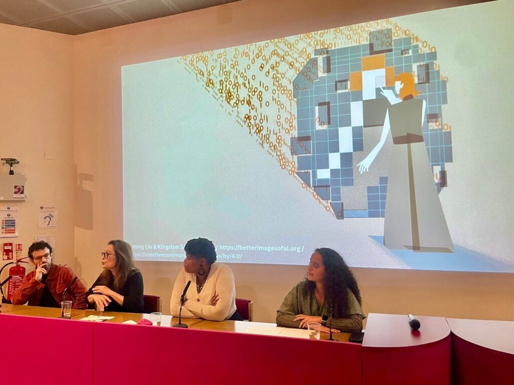 Alex, Tania, Chanelle and Hannah on the panel. Yutong Liu's image "Talking to AI 2.0" is projected in the background. 