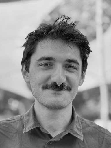 A headshot in black and white of Berk.