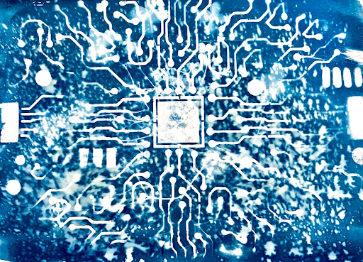 A blue background with a white outline of an AI chip – the effect almost looks like an ink spill or watercolour effect. 