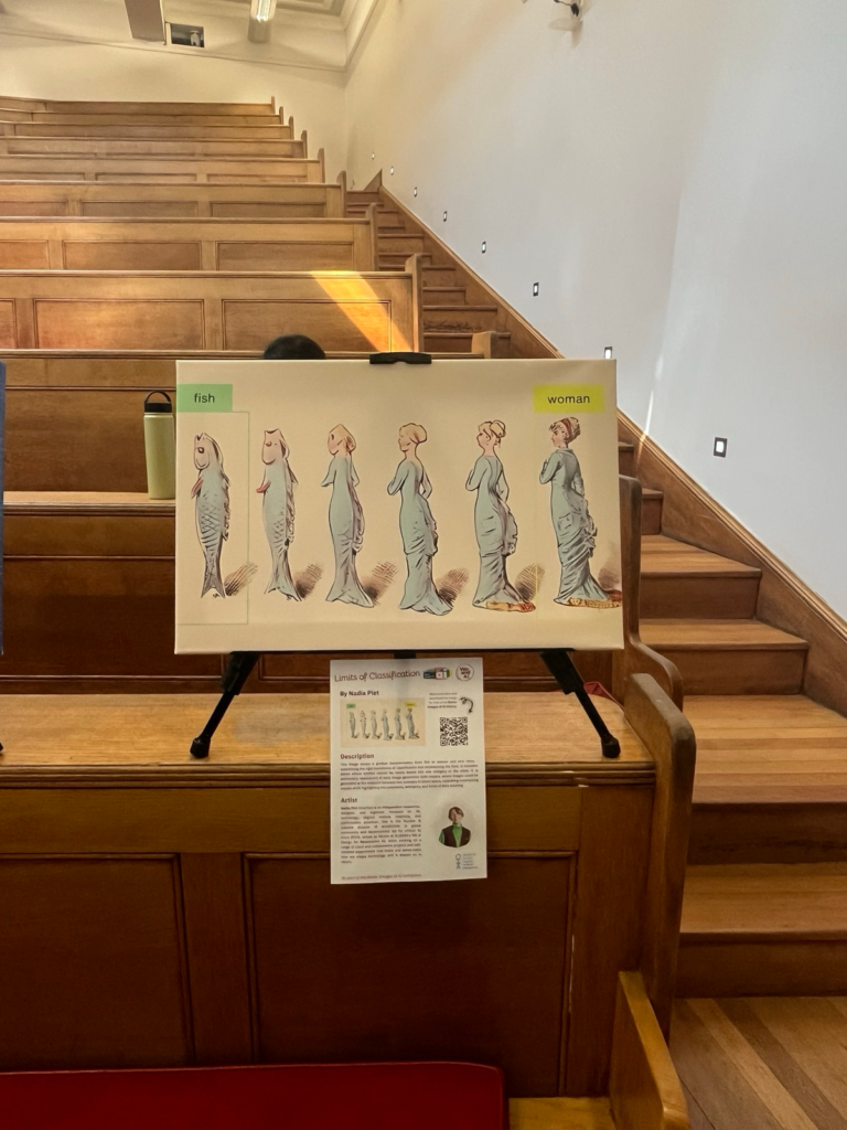 A canvas image of a progression from a fish to a woman, showcasing transitional stages that defy classification boundaries, emphasising fluid states is printed on a canvas and propped up on an easel. In the background are wood rows of benches. 